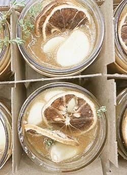 Jars of honey infused with dried citrus and herbs